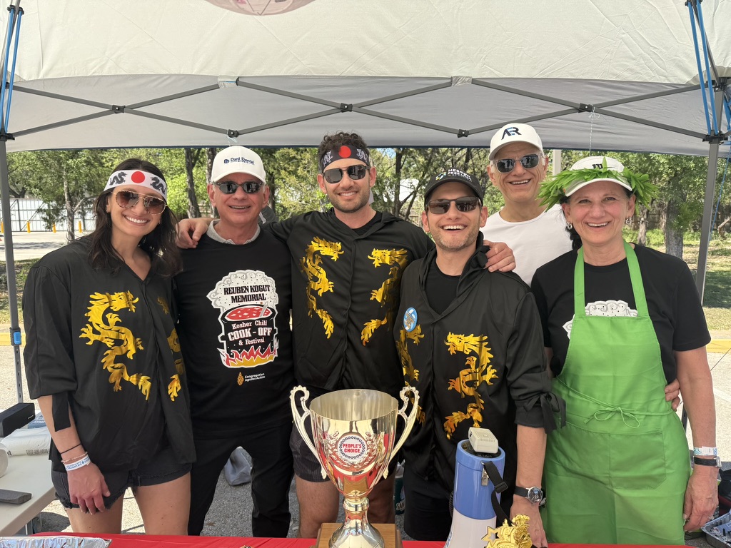 Ben Kogut with his siblings Sara Kogut and Jerrod Kogut at the chili cook-off with the People's Choice trophy