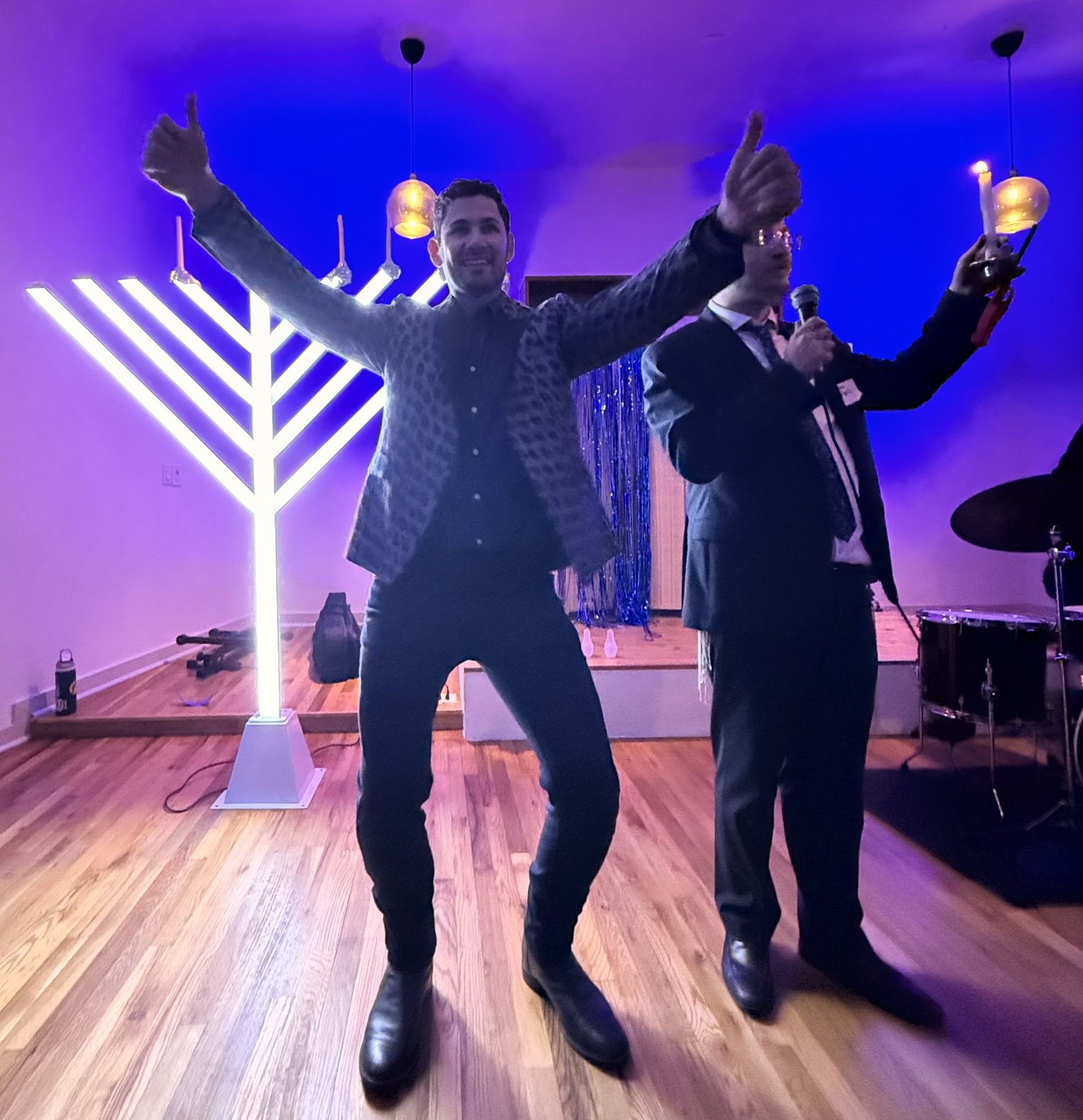 Ben Kogut celebrating on stage at his Austin Chanukah party